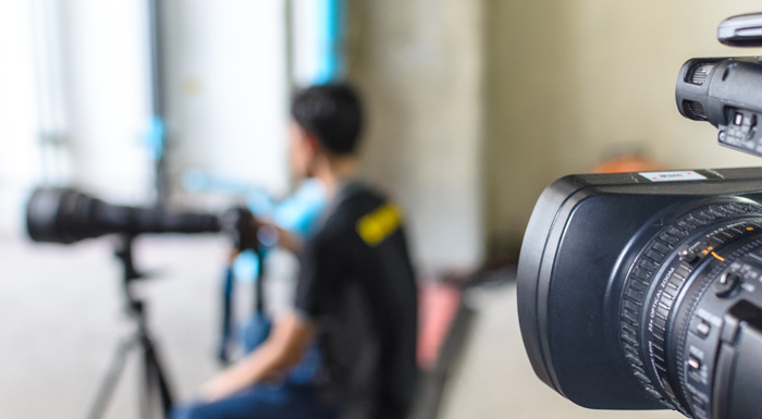 Two video cameras record in a room