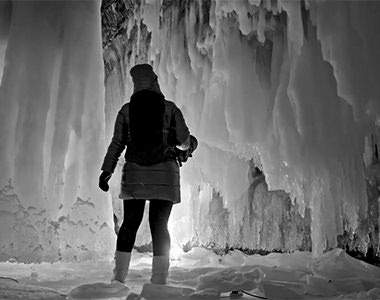 Video screenshot of a person in an ice cave