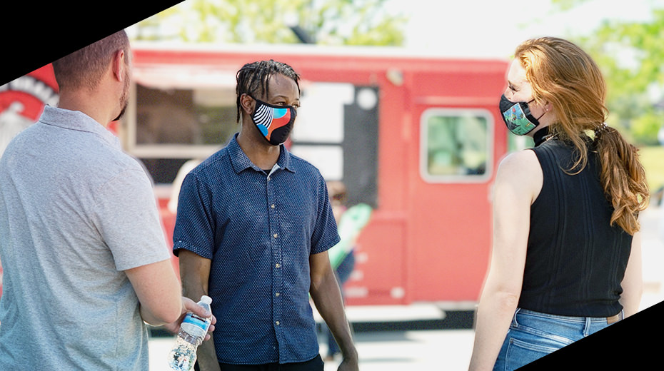 Mx employees chatting outside while wearing masks