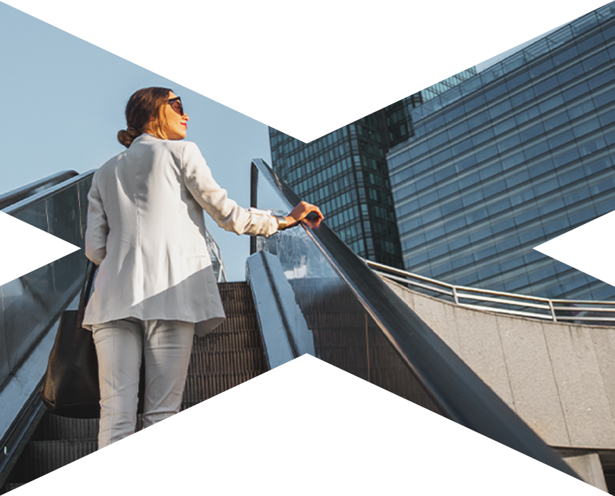 Woman looking up while going up an escalator
