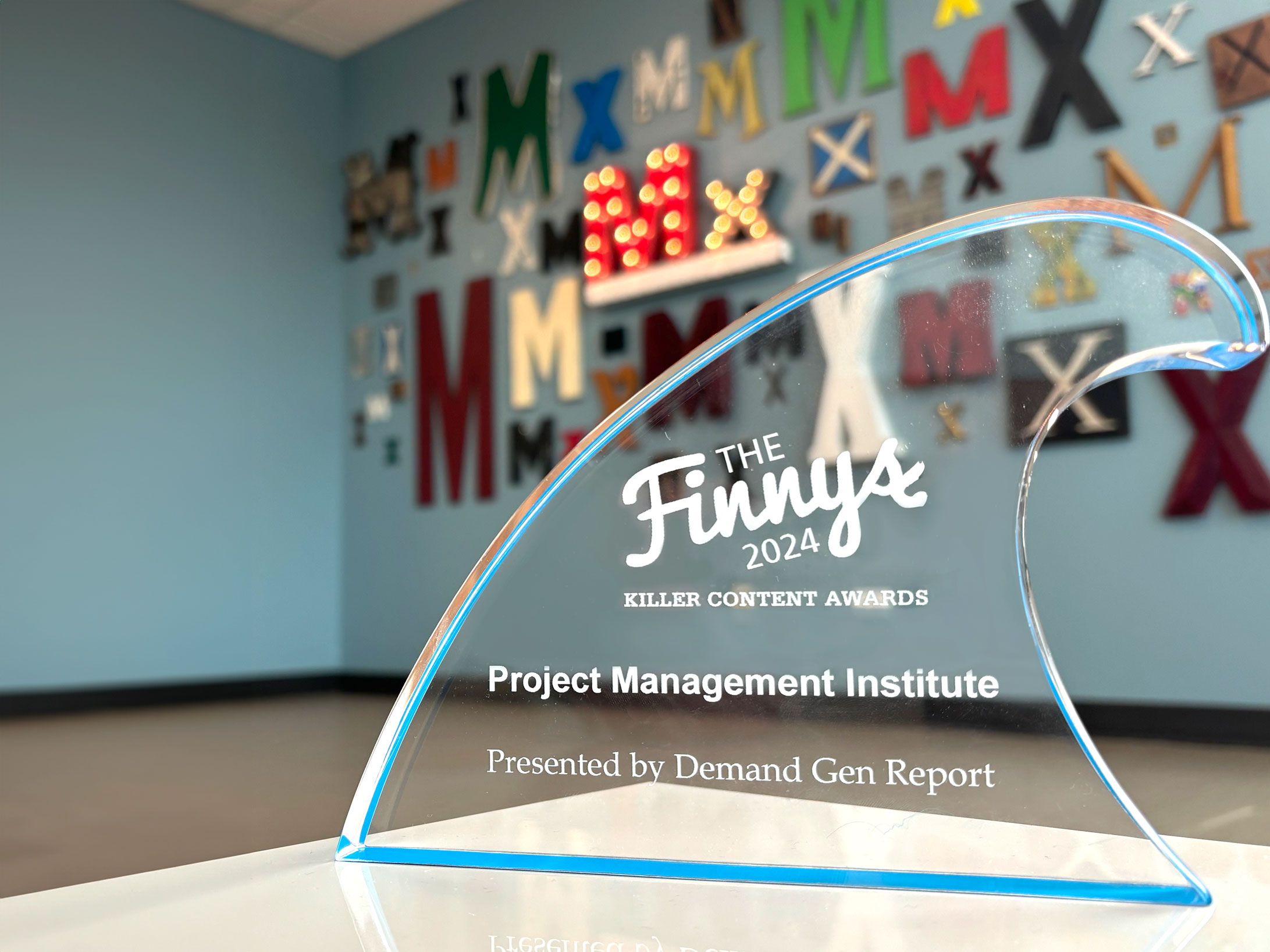 Glass finny award for Project Management Institute's Projectified podcast from Demand Gen Report